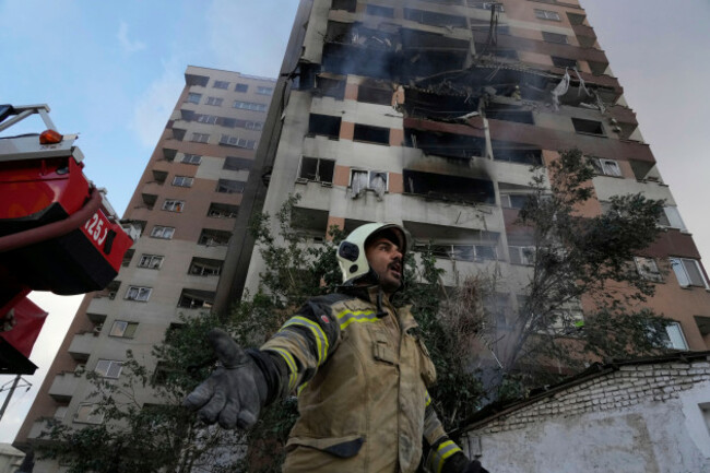a-firefighter-calls-out-his-colleagues-at-the-scene-of-an-explosion-in-a-residence-compound-in-northern-tehran-iran-friday-june-13-2025-ap-photovahid-salemi