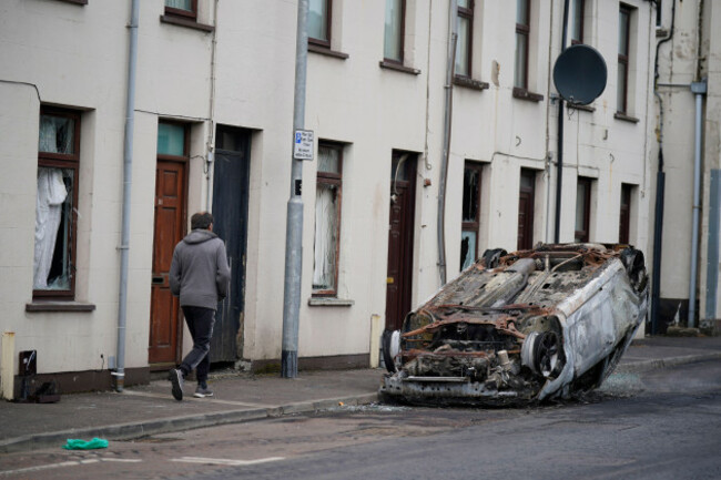 a-burnt-out-overturned-car-on-the-street-following-a-second-night-of-violence-in-ballymena-during-a-protest-over-an-alleged-sexual-assault-in-the-co-antrim-town-multiple-cars-and-properties-were-set
