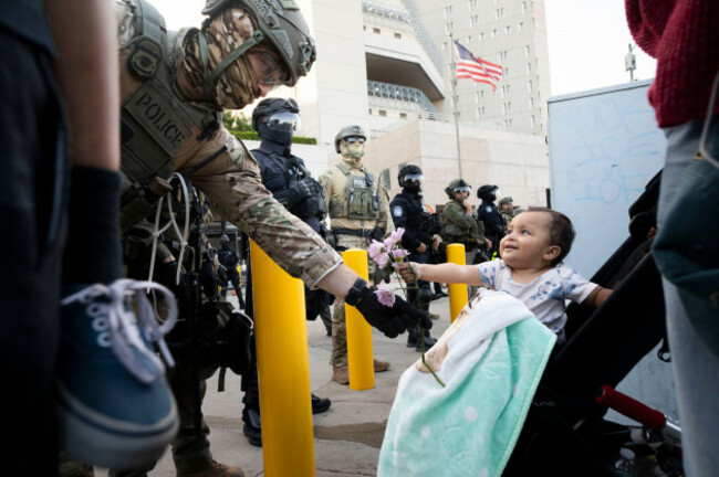 los-angeles-california-usa-13th-june-2025-a-baby-hand-flowers-to-a-member-of-law-enforcement-outside-the-federal-building-during-a-protest-on-friday-june-13-2025-in-los-angeles-a-federal-appe