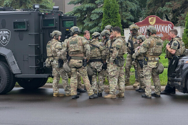 police-deploy-as-a-manhunt-is-underway-for-a-shooter-that-targeted-two-state-lawmakers-in-brooklyn-park-minn-on-saturday-june-14-2025-ap-phototim-sullivan