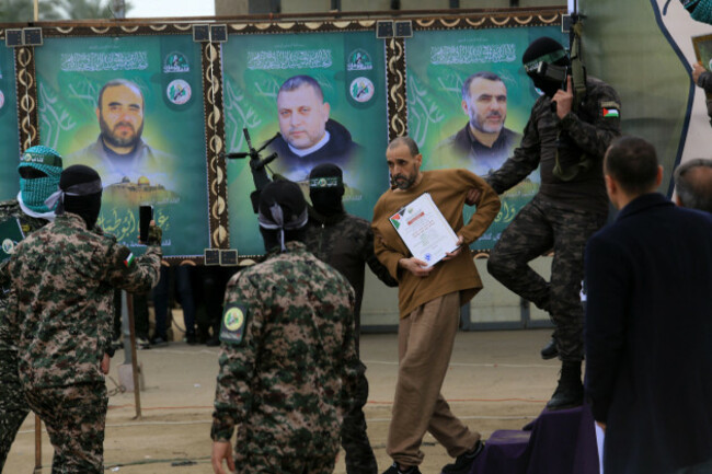 deir-al-balah-gaza-08th-feb-2025-palestinian-hamas-fighters-escort-israeli-hostage-or-levy-on-a-stage-before-handing-him-over-to-a-red-cross-team-in-deir-el-balah-central-gazaon-saturday-on-febru