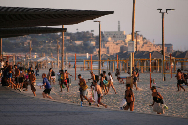 beachgoers-leave-during-a-missile-alert-from-iran-in-tel-aviv-israel-wednesday-june-18-2025-ap-photoohad-zwigenberg