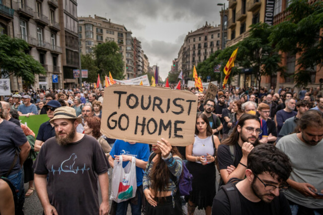 barcelona-spain-19th-june-2024-an-anti-tourism-placard-is-seen-in-the-center-of-the-demonstration-thousands-of-people-have-gathered-on-aragon-street-to-protest-against-the-formula-1-car-exhibitio