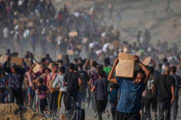 palestinians-carry-sacks-and-boxes-of-food-and-humanitarian-aid-unloaded-from-a-world-food-program-convoy-that-had-been-heading-to-gaza-city-in-the-northern-gaza-strip-monday-june-16-2025-ap-pho