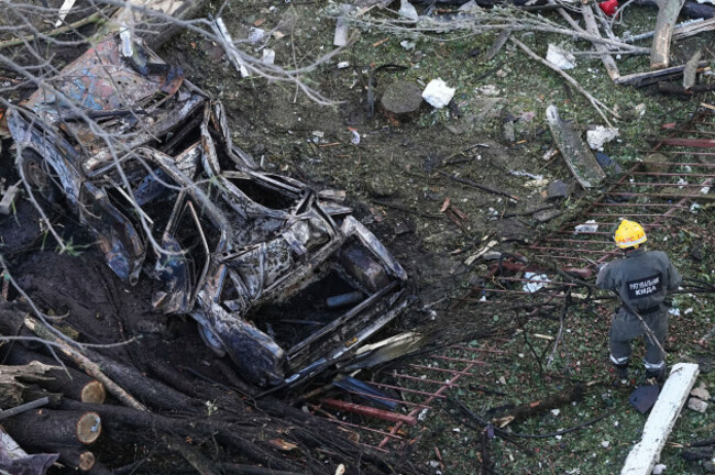 a-destroyed-car-is-seen-as-firefighters-work-on-the-site-of-a-damaged-building-after-a-russian-attack-in-kyiv-ukraine-early-monday-june-23-2025-ap-photoefrem-lukatsky