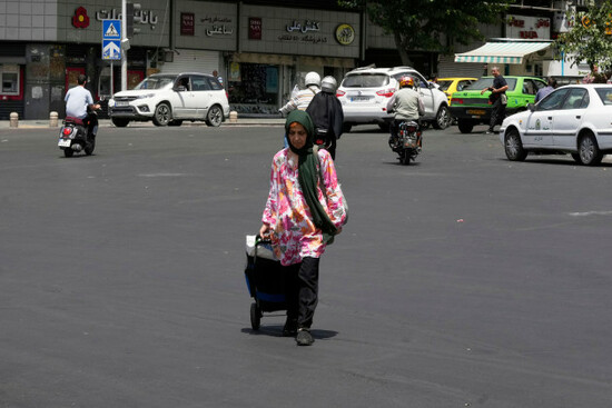 a-woman-carries-a-trolley-at-enqelab-e-eslami-islamic-revolution-square-in-downtown-tehran-iran-tuesday-june-24-2025-ap-photovahid-salemi