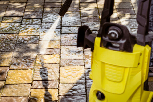 pressurewashinggardenpathfloorcoveringwithhighpressurewasher