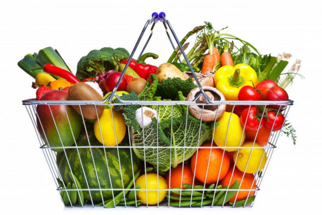 photo-of-a-wire-shopping-basket-full-of-fresh-fruit-and-vegetables-isolated-on-a-white-background