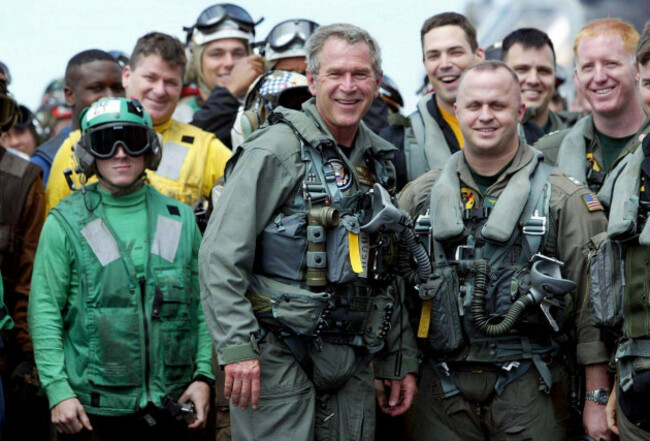 file-president-george-w-bush-poses-with-sailors-and-pilots-aboard-the-uss-abraham-lincoln-off-the-california-coast-after-landing-in-a-small-jet-may-1-2003-ap-photoj-scott-applewhite-file