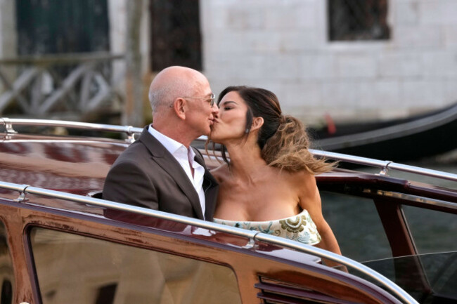 jeff-bezos-center-left-and-lauren-sanchez-center-right-kiss-as-they-leave-a-hotel-for-their-pre-wedding-reception-in-venice-italy-thursday-june-26-2025-ap-photoluca-bruno