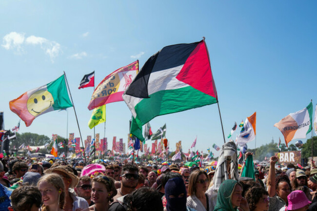 the-flag-of-palestine-is-waved-in-a-crowd-of-festivalgoers-at-the-hip-hop-trio-kneecaps-performance-during-the-glastonbury-festival-in-worthy-farm-somerset-england-saturday-june-28-2025-scott