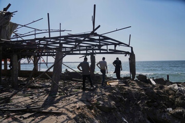 palestinians-walk-in-what-was-a-cafe-after-it-was-damaged-by-an-israeli-strike-in-gaza-city-monday-june-30-2025-ap-photojehad-alshrafi