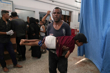 a-man-carries-a-child-who-was-wounded-in-an-israeli-strike-after-being-treated-in-the-shifa-hospital-gaza-city-monday-june-30-2025-ap-photojehad-alshrafi
