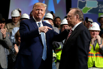 president-donald-trump-gestures-to-harold-hamm-ceo-and-majority-owner-of-north-dakotas-largest-oil-company-continental-resources-as-he-arrives-to-speak-at-the-9th-annual-shale-insight-conference-a