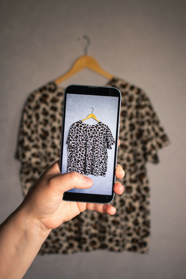 woman-taking-photo-of-her-old-clothes-for-resale-second-hand-concept-closet-organization