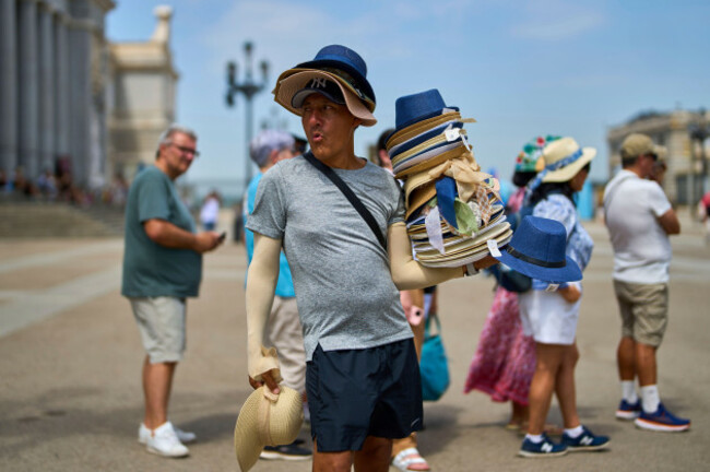 a-vendor-sells-hats-during-a-heat-wave-in-madrid-spain-tuesday-july-1-2025-ap-photomanu-fernandez