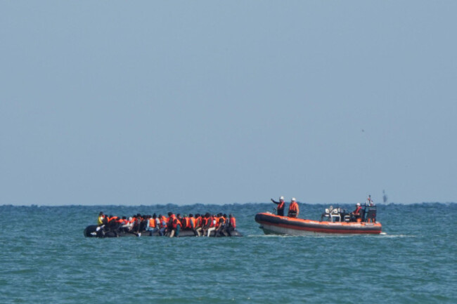 a-boat-intercepts-people-thought-to-be-migrants-on-board-a-rib-rigid-inflatable-boat-in-the-english-channel-off-the-coast-of-calais-france-picture-date-friday-july-4-2025
