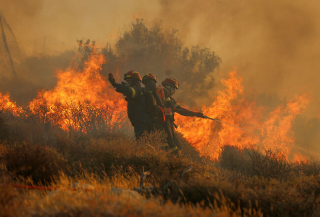 firefighter-uses-a-hose-as-the-try-to-extinguish-the-blaze-near-the-town-of-ierapetra-on-the-south-coast-of-crete-island-greece-thursday-july-3-2025-as-a-fast-moving-wildfire-prompted-authorities