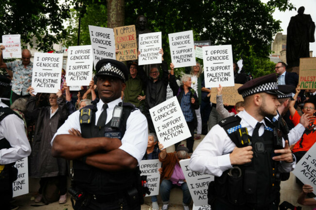 metropolitan-police-officers-observe-a-protest-in-support-of-palestine-action-organised-by-the-defend-our-juries-group-in-front-of-the-mahatma-gandhii-statue-in-parliament-square-central-london-pi