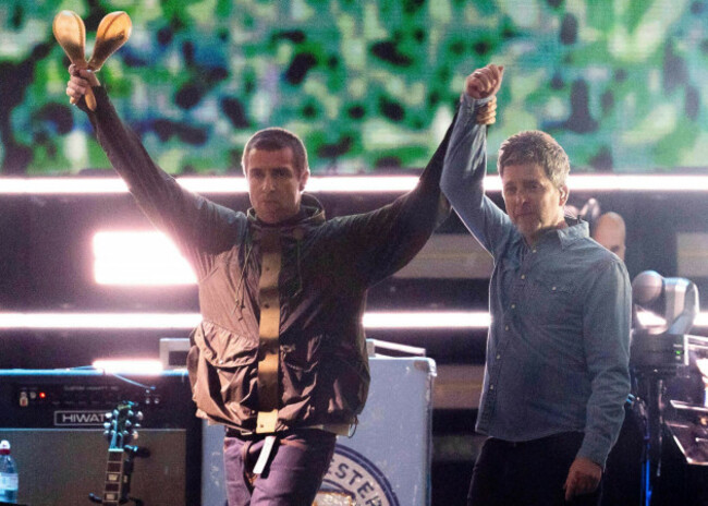 liam-gallagher-left-holds-the-hand-aloft-of-noel-gallagher-from-the-band-oasis-as-they-perform-during-their-reunion-concert-on-friday-july-4-2025-in-cardiff-photo-by-scott-a-garfittinvisionap