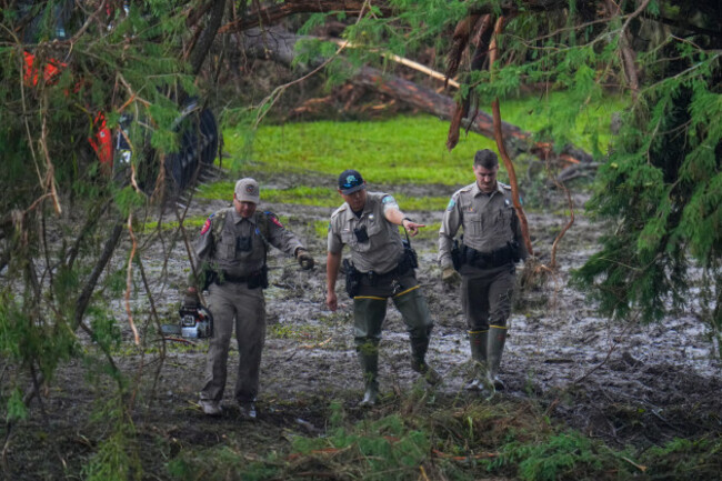 officials-inspect-an-area-at-camp-mystic-along-the-banks-of-the-guadalupe-river-after-a-flash-flood-swept-through-the-area-sunday-july-6-2025-in-hunt-texas-ap-photojulio-cortez