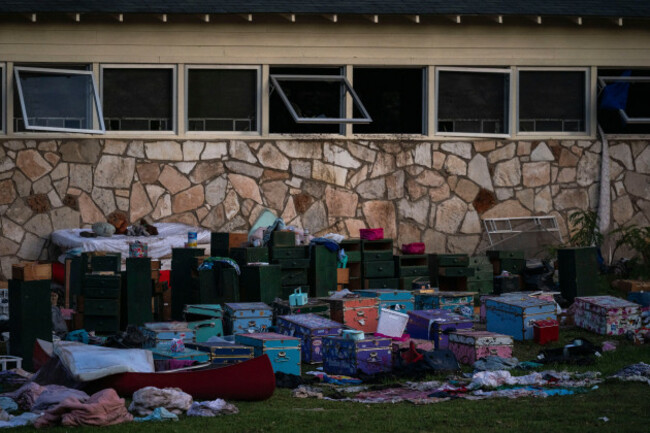 campers-belongings-sit-outside-one-of-camp-mystics-cabins-near-the-guadalupe-river-after-a-flash-flood-swept-through-the-area-monday-july-7-2025-in-hunt-texas-ap-photoeli-hartman