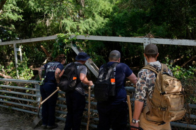 search-and-rescue-teams-from-kerrville-fire-department-search-look-over-the-debris-after-flooding-near-the-banks-of-the-guadalupe-river-in-kerrville-texas-on-tuesday-july-8-2025-ap-photoashley-l