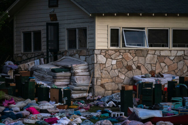 campers-belongings-sit-outside-one-of-camp-mystics-cabins-near-the-guadalupe-river-monday-july-7-2025-in-hunt-texas-after-a-flash-flood-swept-through-the-area-ap-photoeli-hartman