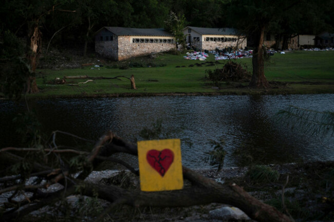 a-broken-heart-sign-is-displayed-near-camp-mystic-on-tuesday-july-8-2025-after-a-flash-flood-swept-through-the-area-in-hunt-texas-ap-photoeli-hartman