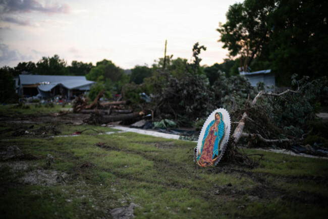 an-virgin-of-guadalupe-icon-is-seen-amongst-the-damaged-property-of-a-home-in-hunt-texas-near-the-guadalupe-river-monday-july-7-2025-after-a-flash-flood-swept-through-the-area-ap-photoeli-har