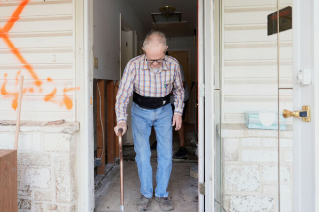 edward-jackson-stands-at-his-door-as-volunteers-help-clean-up-his-house-after-flooding-in-kerrville-texas-on-tuesday-july-8-2025-ap-photoashley-landis