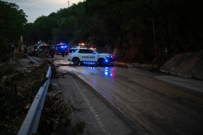 law-enforcement-officials-block-a-road-along-the-guadalupe-river-as-they-load-an-extricated-body-into-the-back-of-a-pickup-truck-in-hunt-texas-monday-july-7-2025-after-a-flash-flood-swept-through