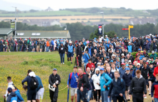 large-crowds-follow-northern-irelands-graeme-mcdowell-on-the-2nd-green-during-day-four-of-the-open-championship-2019-at-royal-portrush-golf-club