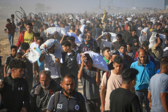 palestinians-carry-boxes-and-bags-containing-food-and-humanitarian-aid-packages-delivered-by-the-gaza-humanitarian-foundation-a-u-s-backed-organization-approved-by-israel-in-rafah-southern-gaza-st