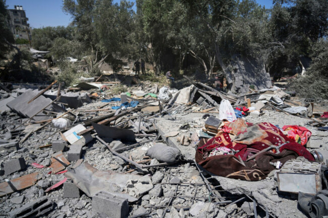 palestinians-inspect-the-site-of-an-israeli-army-strike-on-a-house-belonging-to-the-al-arabid-family-killing-at-least-9-people-in-al-zawida-central-gaza-strip-sunday-july-13-2025-ap-photoabdel