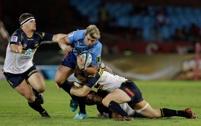 south-africas-bulls-wynand-olivier-center-is-tackled-by-australias-brumbies-ruaidhri-murphy-left-and-teammate-pat-mccabe-right-during-their-super-rugby-match-at-the-loftus-versfeld-stadium-in