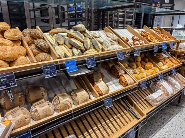 bakery-display-inside-a-supermarket-featuring-shelves-of-various-breads-rolls-and-pastries-with-price-tags-located-in-dublin