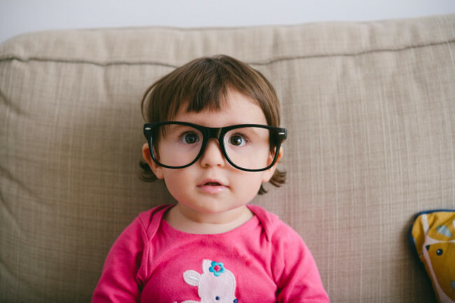 portrait-of-staring-baby-girl-wearing-oversized-glasses