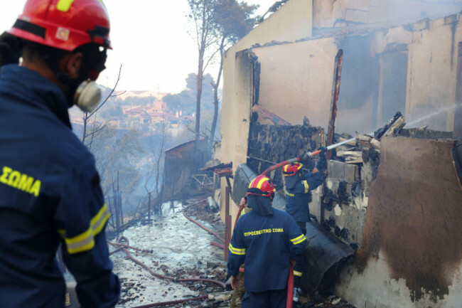 firefighters-try-to-extinguish-a-fire-at-house-during-a-wildfire-in-the-northwestern-suburb-of-kryoneri-in-athens-greece-saturday-july-26-2025-ap-photoyorgos-karahalis