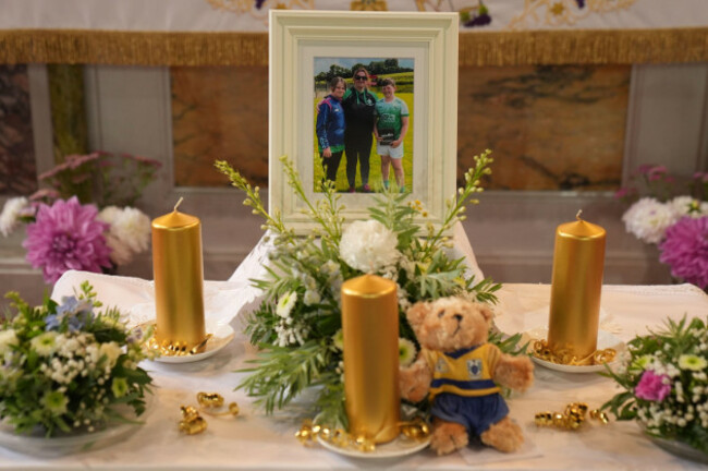 a-photograph-and-a-soft-toy-amongst-flowers-on-the-altar-at-a-prayer-service-at-the-church-of-the-immaculate-conception-barefield-republic-of-ireland-for-vanessa-whyte-and-her-children-james-and-s