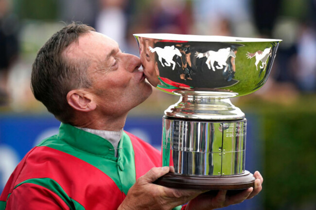 jockey-james-anthony-seamie-heffernan-kisses-the-trophy-after-winning-the-colm-quinn-bmw-mile-handicap-with-horse-dunum-on-day-2-of-the-galway-races-summer-festival-at-galway-racecourse-ireland-pi