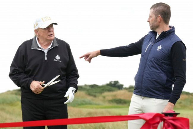 president-donald-trump-holds-a-scissors-as-his-son-eric-trump-gestures-during-an-opening-ceremony-for-the-trump-international-golf-links-golf-course-near-aberdeen-scotland-tuesday-july-29-2025