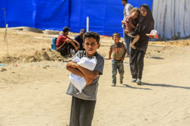rafah-gaza-30th-july-2025-a-palestinian-boy-carry-aid-after-receiving-it-from-the-us-humanitarian-aid-distribution-centre-in-rafah-southern-gaza-on-wednesday-july-30-2025-according-to-press-rep