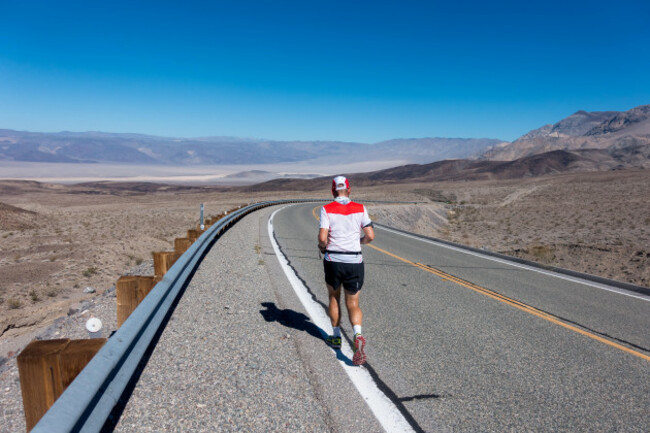 lone-runner-in-death-valley-during-badwater-135-miles-ultramarathon-running-in-the-afternoon-sun