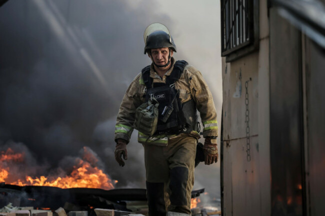 in-this-photo-provided-by-ukraines-24th-mechanized-brigade-press-service-a-firefighter-puts-out-the-fire-after-a-russian-drone-hit-the-market-in-the-town-of-druzhkivka-donetsk-region-ukraine-satu