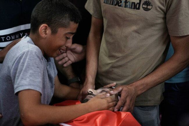abdul-latif-ayyad-mourns-over-the-body-of-his-uncle-the-palestinian-american-khamis-ayyad-40-who-died-while-trying-to-extinguish-a-fire-during-an-israeli-settlers-attack-at-his-funeral-in-the-west