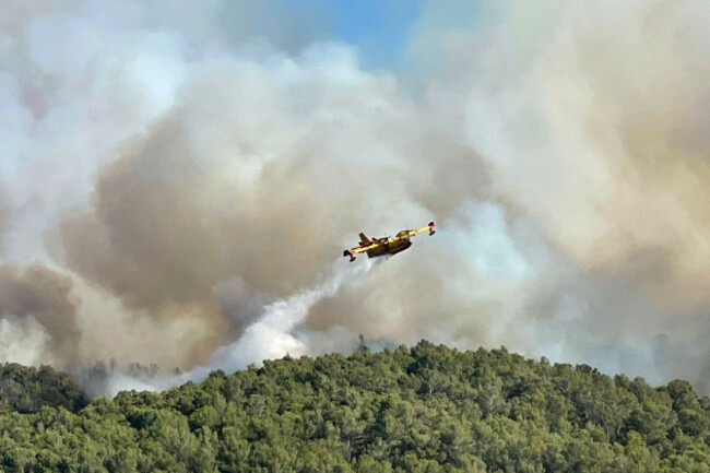 this-photo-provided-by-the-securite-civile-shows-a-water-bomber-plane-dropping-water-on-the-wildfire-in-the-corbieres-massif-southern-france-tuesday-aug-5-2025-securite-civile-via-ap