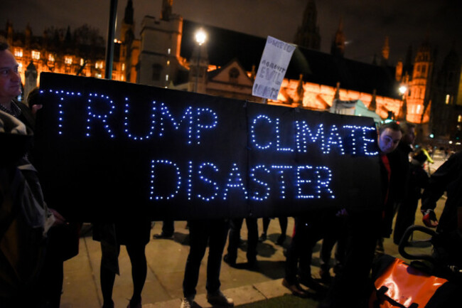 london-uk-20th-february-2017-people-gathered-at-parliament-square-to-protest-against-brexit-and-proposed-donald-trumps-state-visit-to-britain-protesters-are-carrying-a-banner-reading-trump-clim