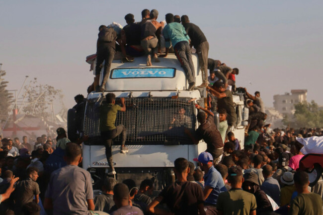 palestinians-ride-on-a-truck-loaded-with-food-and-humanitarian-aid-as-it-moves-along-the-morag-corridor-near-rafah-in-the-southern-gaza-strip-monday-aug-4-2025-ap-photomariam-dagga
