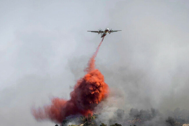 this-photo-provided-by-the-regional-prefecture-shows-a-water-bomber-dropping-liquid-on-a-fast-moving-wildfire-in-a-mediterranean-region-of-france-near-the-spanish-border-tuesday-aug-5-2025-sandri